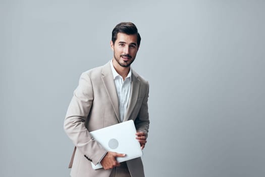 notebook man adult male internet copyspace handsome studio portrait businessman freelancer technology job happy smiling cheerful suit laptop business computer wireless