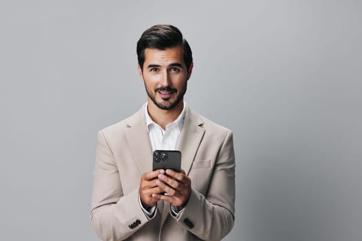 man gray phone hold mobile businessman copy suit entrepreneur holding portrait space smartphone male business smile technology happy studio call background connection