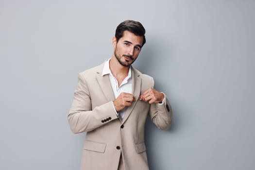 young man grey copyspace male crossed fashion sexy suit businessman smiling handsome attractive office happy tie portrait occupation business studio beige