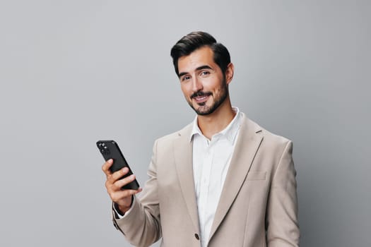 holding man space businessman business phone cyberspace smartphone cellphone young guy call suit portrait copy studio hold beard trading happy communication smile