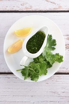 Green delicious herbal marinade of cilantro, basil, parsley, oil, traditional seasoning for salad dressing