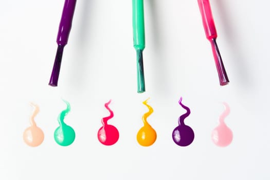 brush strokes and colorful nail polish on white