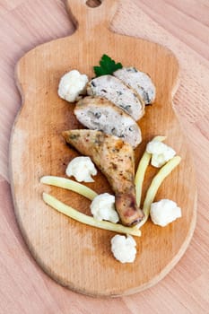 Grilled barbecue chicken quarters on a cutting board