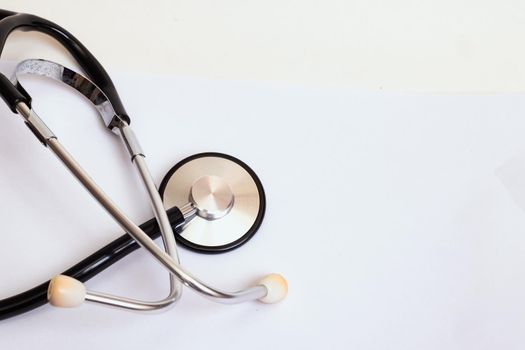 Part of a stethoscope on a blue background close up, copy space