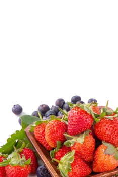 A bowl set of beautiful and delicious strawberry and blueberry isolated on white background, close up, copy space, clipping path, cut out.