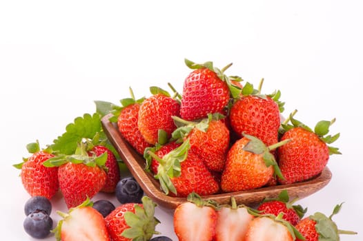 A bowl set of beautiful and delicious strawberry and blueberry isolated on white background, close up, copy space, clipping path, cut out.