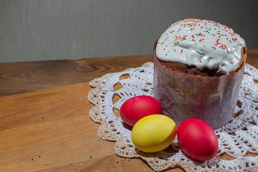 Traditional easter cake and colorful easter eggs on wooden background. Easter concept.