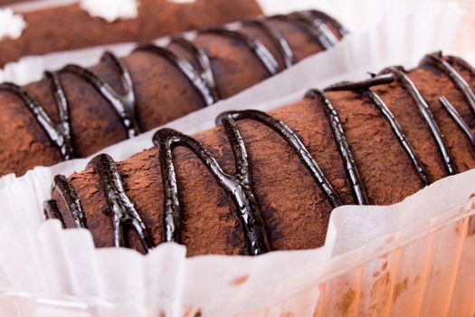 Chocolate cakes with cream close up on wooden table