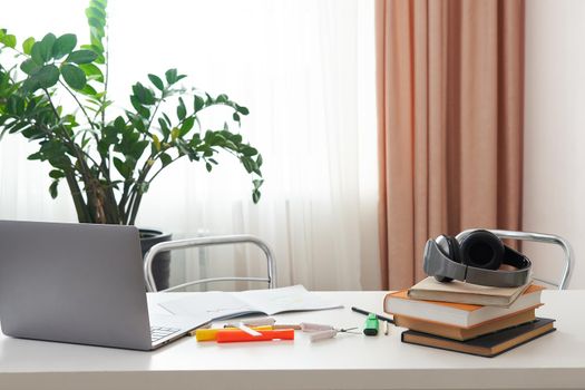 concept of home office, Empty work place with laptop and books on a desk, interior design of student or freelance employee,