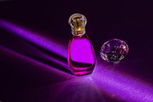 Perfume bottles studio shot on colored background with reflection. Perfumes, cosmetics, a collection of fragrances.