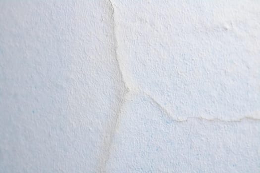 Crack on a white painted wall close up