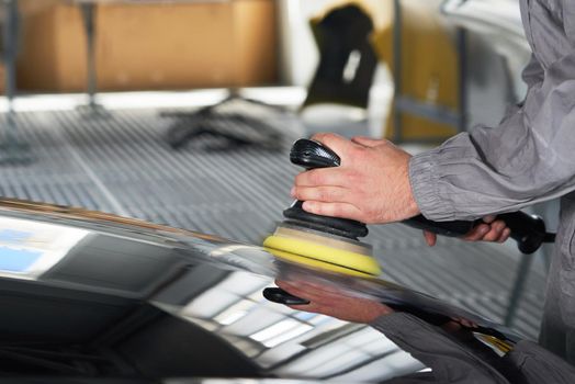 hands holding the work tool polish car, Auto Mechanic Polishing Car