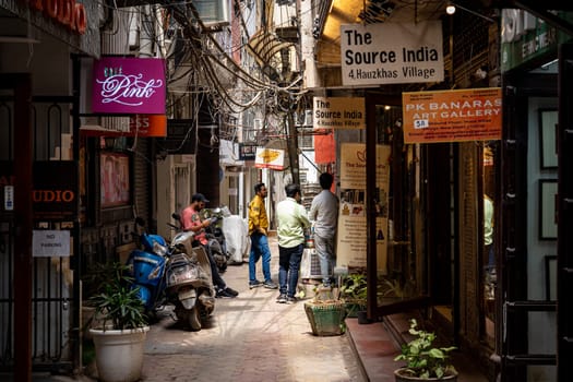 New Delhi, India - March 30, 2023: People and shops in Hauz Khas Village neighboorhoud