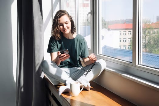 Digital Lifestyle: Woman Engaged in Productive Home Communication and Mobile Apps - Student Balancing Work, Study, and Connectivity in the Comfort of Her Room.