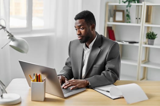 man african indoor looking american computer businessman conference freelancer job smiling young sitting using office education american laptop student entrepreneur online business