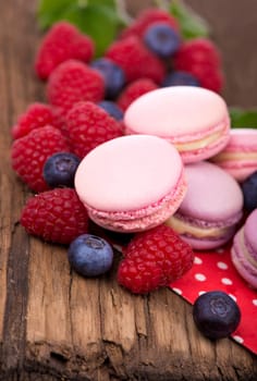 Macaroon with raspberries cookies on a wooden background