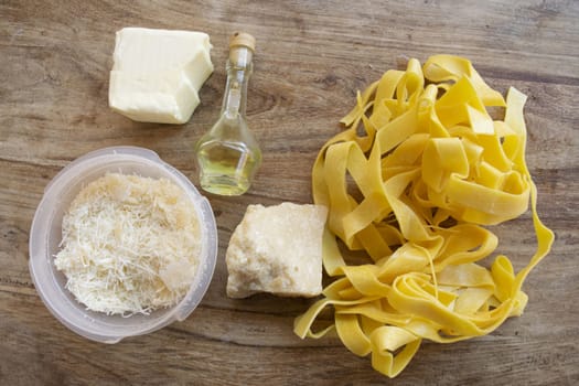 ingredients to making  fettuccine Alfredo with butter parmesan cheese and olive oil