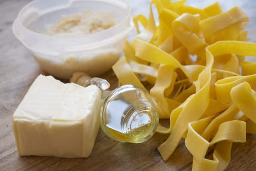 ingredients to making  fettuccine Alfredo with butter parmesan cheese and olive oil