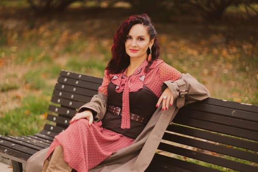 A woman walks outdoors in autumn, enjoys the autumn weather