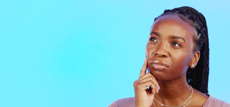 Thinking, idea and black woman in doubt with mockup and confusion isolated on blue background. Ideas, concentration and difficult choice for African in studio space with thoughtful expression on face.