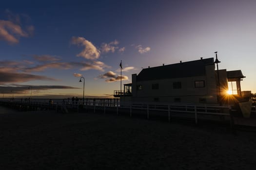 Kerford Rd Pier and Albert Park Yachting & Angling Club in Albert Park at sunset on a winter's evening in Melbourne, Victoria, Australia