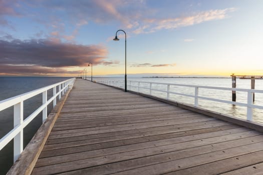 Kerford Rd Pier and Albert Park Yachting & Angling Club in Albert Park at sunset on a winter's evening in Melbourne, Victoria, Australia