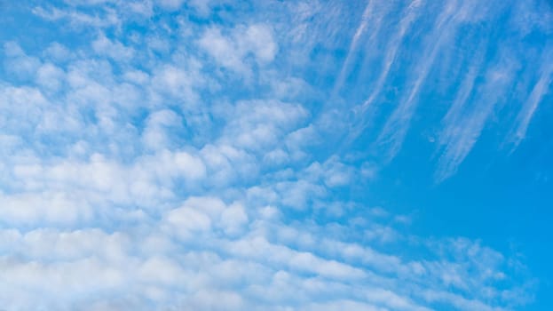 Summer bright blue sky with clouds outdoor background