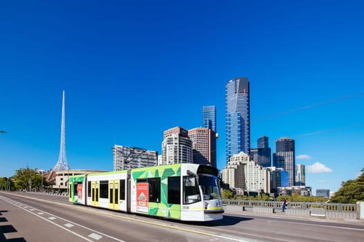 MELBOURNE, AUSTRALIA - OCTOBER 31, 2021: Views towards Melbourne CBD and Princes Bridge with a tram along the Yarra River in Melbourne, Victoria, Australia