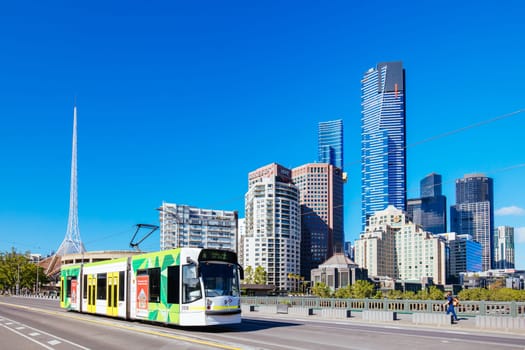 MELBOURNE, AUSTRALIA - OCTOBER 31, 2021: Views towards Melbourne CBD and Princes Bridge with a tram along the Yarra River in Melbourne, Victoria, Australia