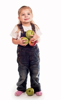 The little girl plays with apples on a white background