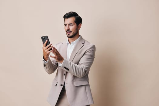 man entrepreneur blogger adult mobile smile hold young phone studio mobile smartphone happy portrait technology handsome call suit business selfies person phone