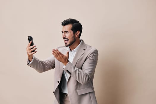 man suit phone gray smartphone beige phone smile call hold holding technology studio mobile business background handsome portrait communication cell happy white