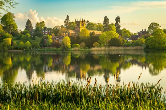 Town of Ellesmere in Shropshire with reflection view from across the Mere to the Church