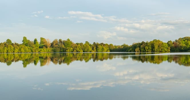 Panorama of the lake shore of the Mere with a perfect lake reflection in Ellesmere in Shropshire