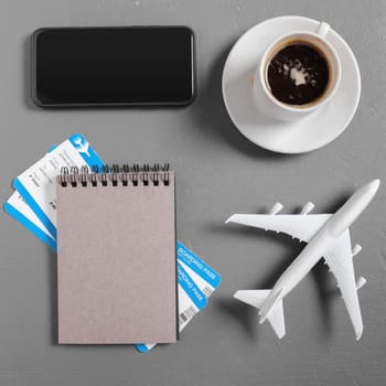 boarding pass and toy airplane on table top view