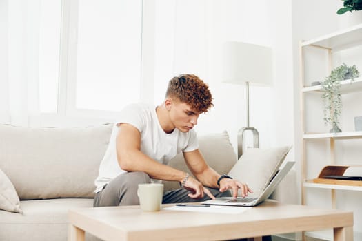 man interior browsing using computer business internet home student lifestyle chat room call happy curly blissful male white
