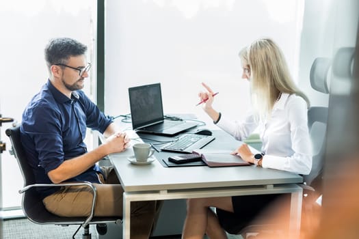 Business meeting. Client consulting. Confident business woman, real estate agent, financial advisor explaining details of project or financial product to client in office