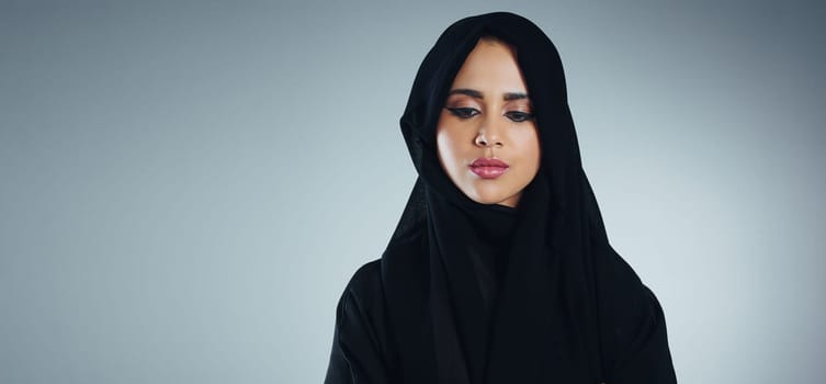 Shes got Islam in her heart. Studio shot of a young muslim businesswoman against a grey background