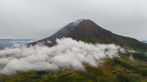 Active volcano Sinabung with clouds and smoke. Sumatra, Indonesia.