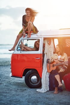 Play another one. a group of young friends stopping at the beach during a roadtrip