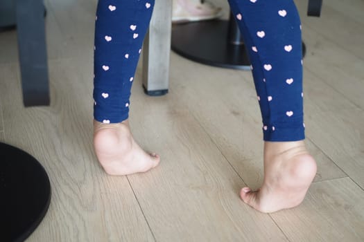 low angle view of A child walking on tiptoes.