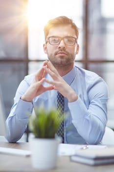 Young cheerful businessman working at office