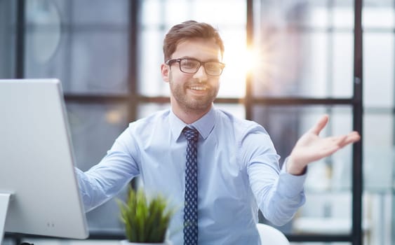 Young cheerful businessman working at office