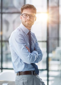 Young cheerful businessman working at office