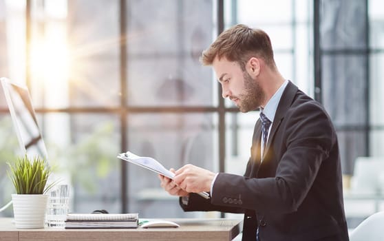 Businessman Taking Papers From Secretary In Office