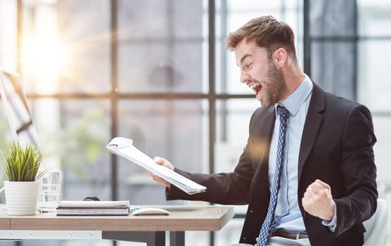 energetic businessman celebrating in office
