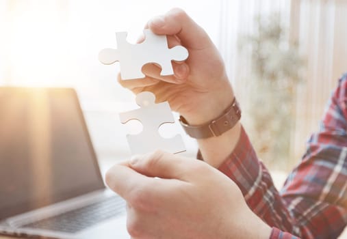 Businessman hands connecting jigsaw puzzle. Business solutions, success and strategy