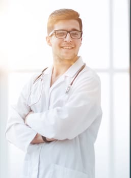 Portrait of young, doctor sitting in medical office