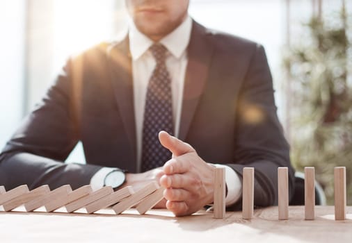 Businessman with dominoes in the office