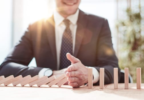 Businessman with dominoes in the office